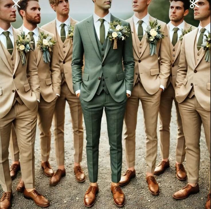 A man in a sage green three-piece suit stands among groomsmen in tan suits.